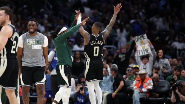 Milwaukee Bucks guard Damian Lillard (0) celebrates with teammates after making a three point basket